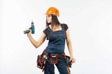 Evde çalışma için matkap ve bazı güç araçlarını kullanarak toolbelt olan kadın. Düz beyaz arka plan üzerinde remodeling çalışan kız. Bina, onarım ve yenileme.