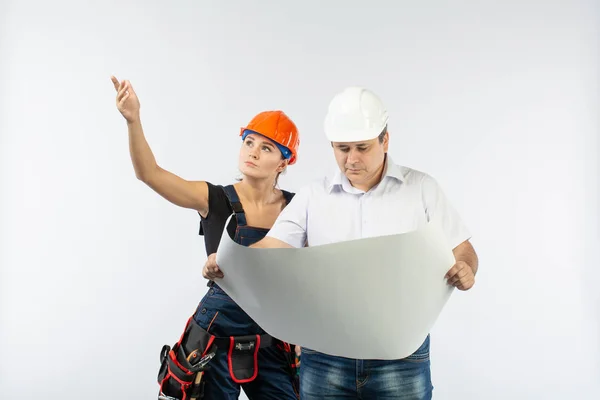 contractors people discussing the plan of building over white background. Foreman with builder woman wearing helmets.