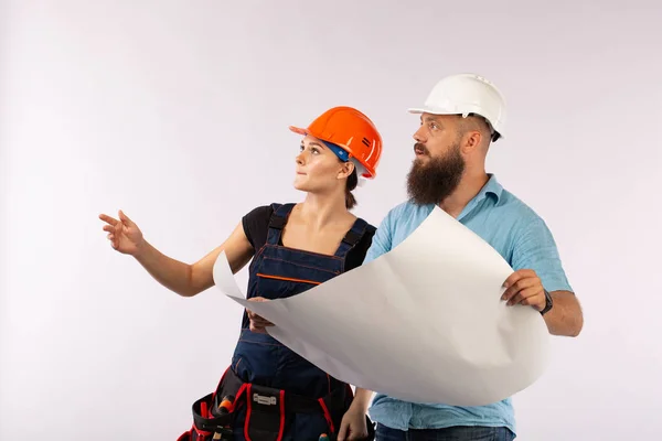 A male architect or engineer meeting with a building woman contractor on white background. The process of discussimg the plam of building. Bisiness concept. discussion of the repair plan