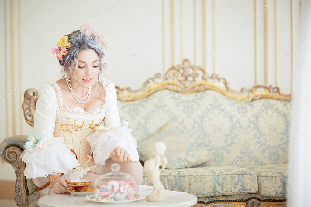 Beautiful greyhead woman in Rococo dress posing in front of pink background while drinking tea. halloween