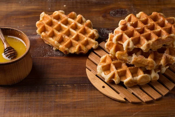Honey Waffle Put On white Plate, homemade honey waffle put on wooden table, delicious honey waffle