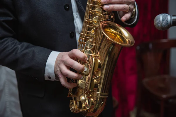 萨克斯管演奏者萨克斯管演奏者的手演奏萨克斯管。alto sax 播放器与爵士乐乐器 — 图库照片