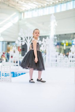 Kyiv, Ukraine March 03.2019. UKFW. Ukrainian Kids Fashion Day. Little girl model weared at black dress posing at the podium clipart