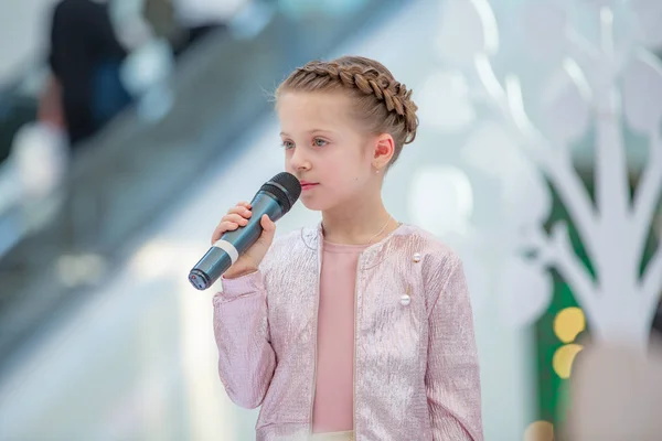 Kiev, Ukraina mars 03.2019. Ukfw. Ukrainska barn mode dag. Flickan håller mikrofonen i handen medan du utför låt vid evenemanget — Stockfoto