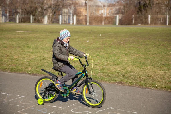 little boy riding runbike, early sport. child learns to ride a bike