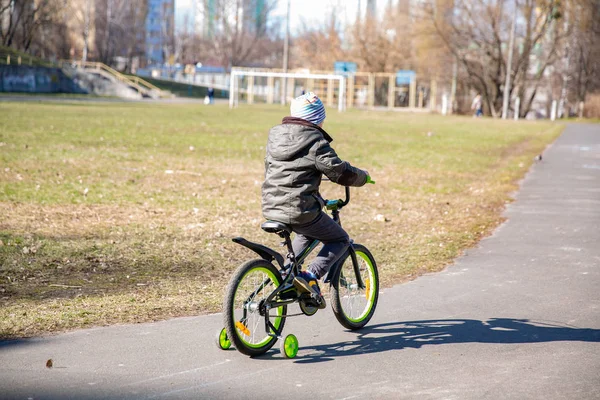 little boy riding runbike, early sport. child learns to ride a bike