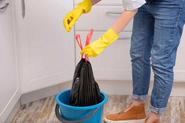 hand holding a trash garbage bag at home to take it away