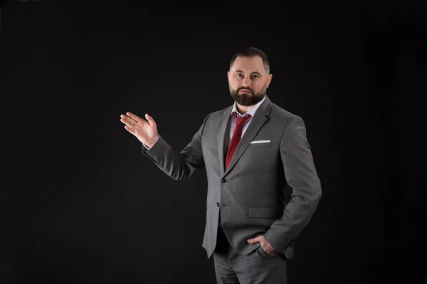 Portrait of young handsome business man presenting gesture on black background — Stock Photo, Image