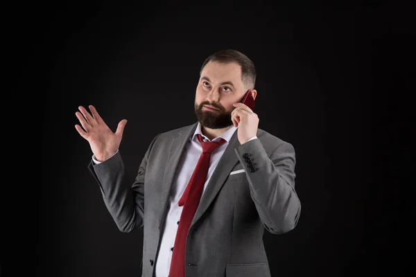 Guy call friend stand black background. Mobile call concept. Man formal suit call someone. Mobile call conversation. Mobile negotiations. Businessman well groomed mature man hold smartphone.