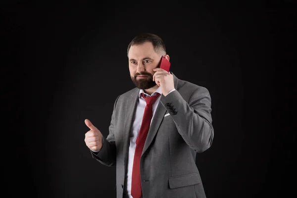 Guy call friend stand black background. Mobile call concept. Man formal suit call someone. Mobile call conversation. Mobile negotiations. Businessman well groomed mature man hold smartphone.