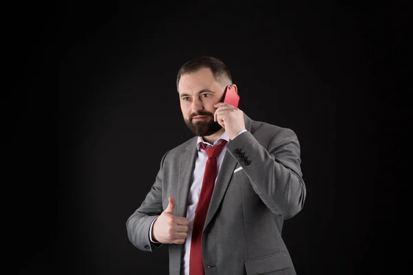 Guy call friend stand black background. Mobile call concept. Man formal suit call someone. Mobile call conversation. Mobile negotiations. Businessman well groomed mature man hold smartphone.