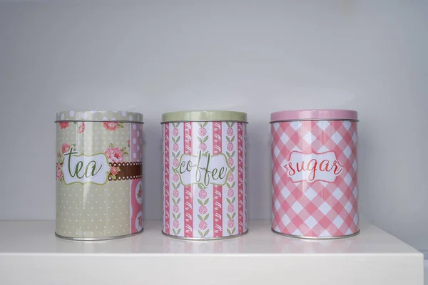 Tea coffee and sugar canisters on a kitchen bench