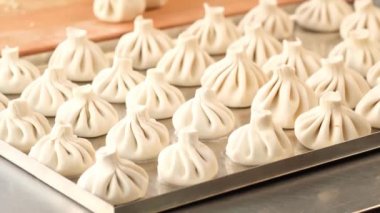 Ulusal Gürcü mutfağı. Khinkali metal arka plan. Cook khinkali hazırlar. Mutfak. Üst görünümü çiğ et hamuru yemek pişmemiş. Sokak yemek kabini satıyor. Çin özel Buharlı. Köfte Süreci pişirme.