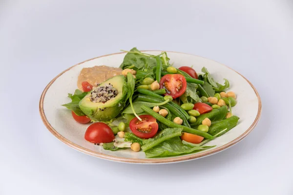 Healthy natural food. Salad with green vegetables, vitamins on the plate.