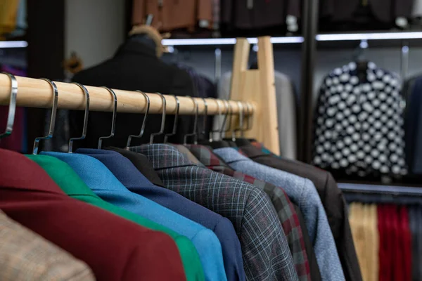 expensive men s clothing store. a row of jackets on hangers