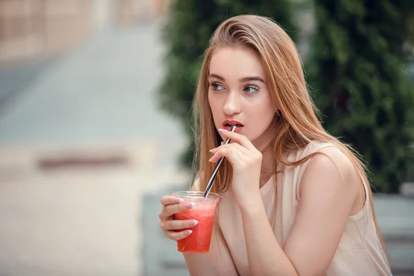 Outdoor fashion beauty portrait of glamour elegant lady, amazing long hairs, drinking tasty cold cocktails, city cafe terrace, travel, joy, relax. quench your thirst in hot summer