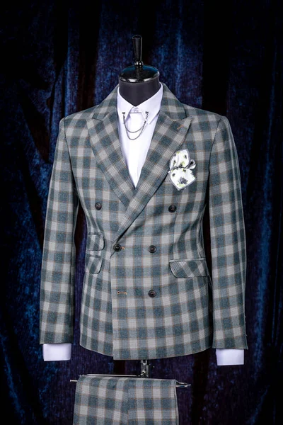 Stylish mens gray check suit on a mannequin or dummy. Mens Clothing. Clothing store. Shopping in boutiques