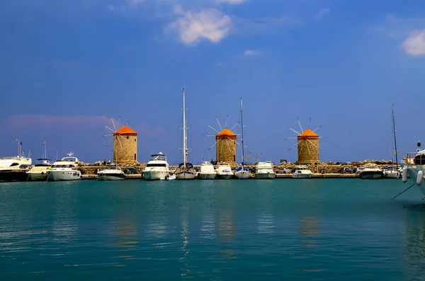 Antique Yellow Orange Windmills Port Mandraki White Yachts Turquoise Sea — Stock Photo, Image