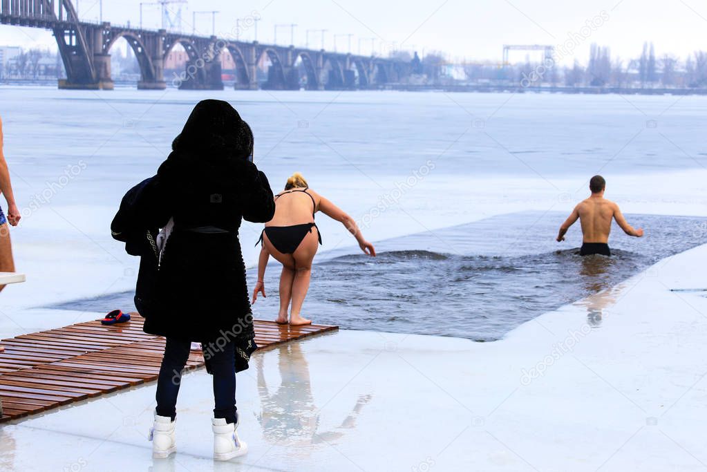 Winter sports, Hardening. People swimming in the river holes.  Orthodox holiday of Epiphany, Dnipro city, Dnepropetrovsk, Ukraine,