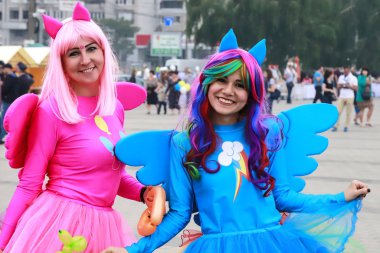 Dnepr city, 5 09 2019. Mavi ve pembe parlak karnaval elbise iki komik genç kız gülümseyerek ve sokağın Dnepropetrovsk Festival boyunca yürüyüş. Tatil kavramı