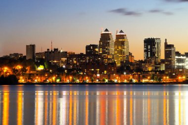 Gece büyük şehir. Güzel yüksek binalar, gökdelenler ve akşamları Nehir üzerinde kuleleri. Dnipro, Dnepropetrovsk, Ukrayna, ilkbahar, sonbahar, yaz