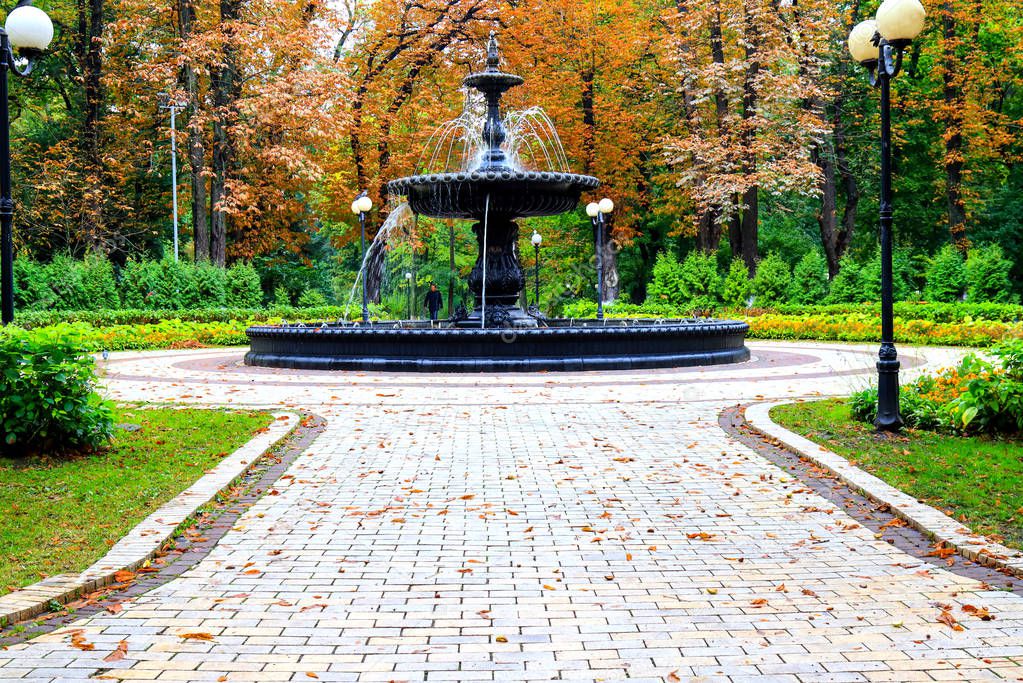 Autumn city landscape. Beautiful old fountain in the autumn park after the rain. Mariinsky Park near the Parliament of Ukraine, Verkhovna Rada, city Kiev