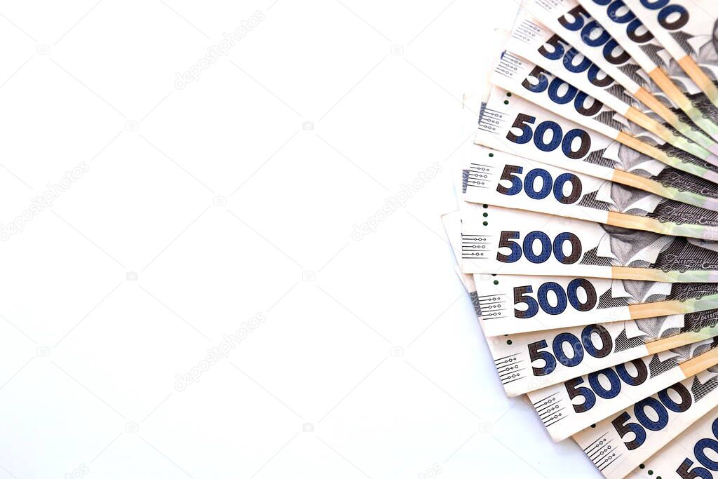 Ukrainian hryvnia, new banknotes of 500 hryvnias on a white background, diagonal position, close-up, isolated. Money background, concept of gifts, shopping, space for text. Ukraine