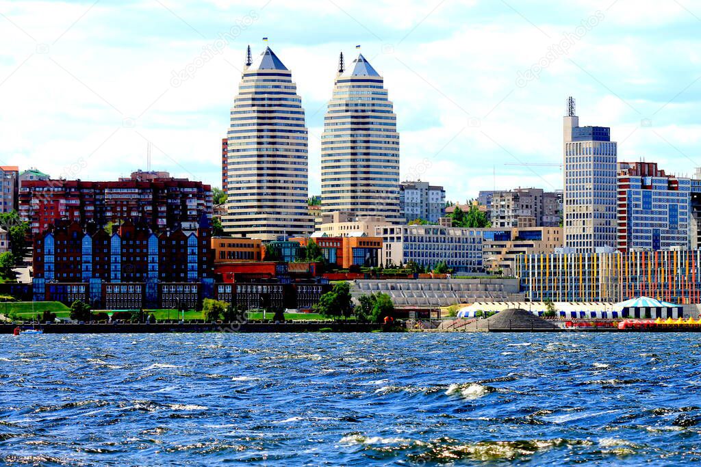 Windy day, waves on the Dnieper river, views of the buildings, towers and skyscrapers of the Dnipro city, cityscape. Dnepropetrovsk, Ukraine