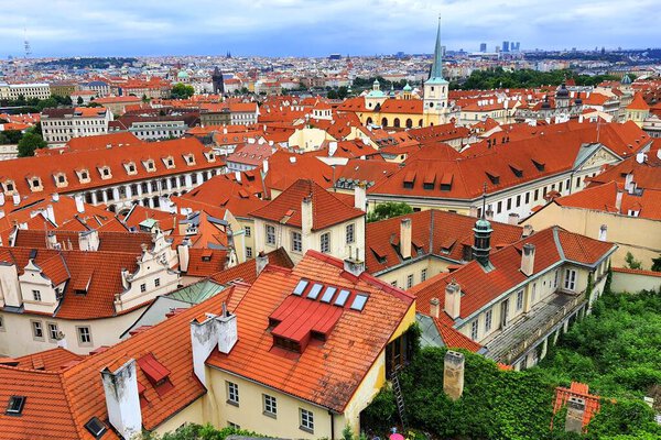 Prague, Czech Republic. Mala Strana, Old Town of Prague. Top view of downtown, panorama. Ancient old buildings with red tiled roofs, church, tower, castle