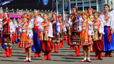 Dnipro, Ukraine, 13 09 2014. People in national Ukrainian costumes and embroidered shirts sing the anthem of Ukraine in the City Day celebration. Ukrainian patriotism, patriots