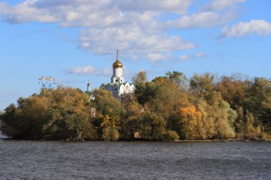 Dnipro city, Ukraine. Yellow trees in autumn and church on island on Dnipro river, Ukraine, autumn landscape. Calendar, postcard of seasons - October, November, wallpaper