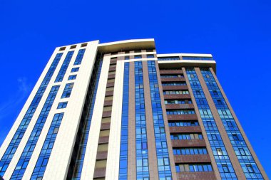 The facade of a blue residential building with panoramic windows. Residential building, tower against the sky, Dnipro, Dnepr, Ukraine