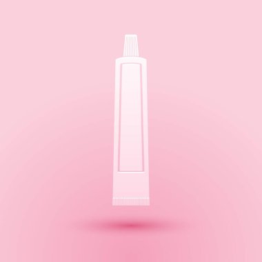 Pembe arka planda izole edilmiş kağıt kesiği diş macunu ikonu tüpü. Kağıt sanatı tarzı. Vektör.