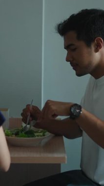 Mutlu çift modern dairelerinde taze salata yiyorlar.