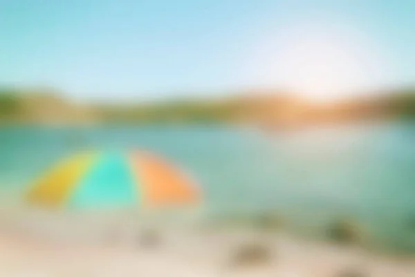 Blurred background. Beach vacation concept. Summer holiday concept. Sunset on the ocean. Turquoise orange green tones.