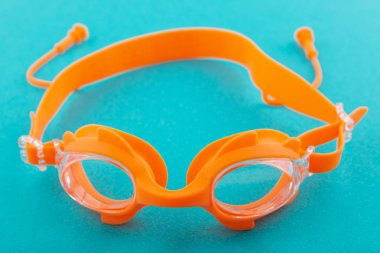 Turkuaz bir arka plan üzerinde genel kavram-in spor yüzme turuncu gözlük