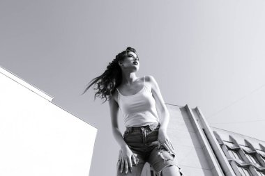 Genç, güzel esmer kadın poz veriyor.