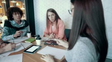 Kağıt iş üzerinde kadın takım lideri yazar çok ırklı yaratıcı iş takım toplantısı ofis planı