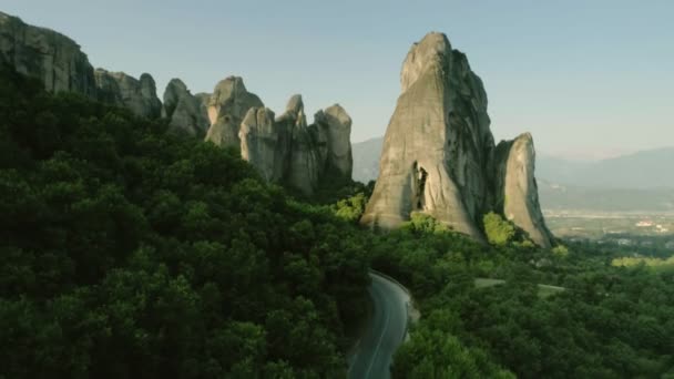 Lugar histórico con altas montañas y acantilado Meteora paisaje plano aéreo en Grecia al atardecer — Vídeo de stock