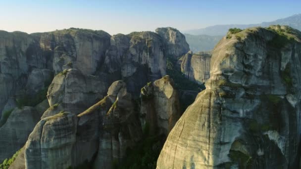 Meteora taşın Kalambaka günbatımı yükseliyor, yüksek dağlarla çevrelenmiş şehir üzerinde kalkış — Stok video