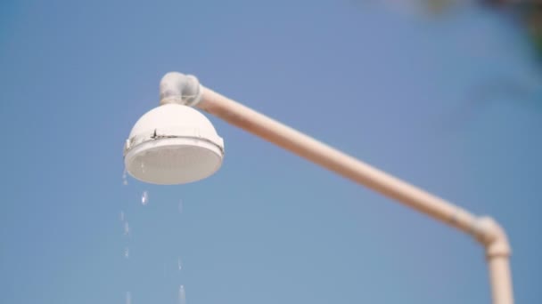 Primer plano de la ducha al aire libre en la playa con gotas de agua limpia en cámara lenta — Vídeo de stock