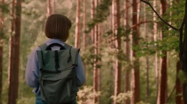 Woman hipster traveller enjoying wonderful nature and looking around low angle
