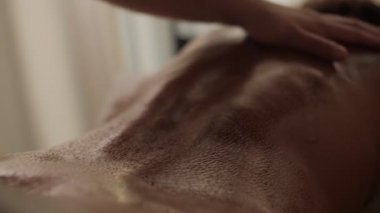 Masörün elleri, masaj yapan kadının sırtını okşuyor. Güzellik salonuna masaj yapıyor.