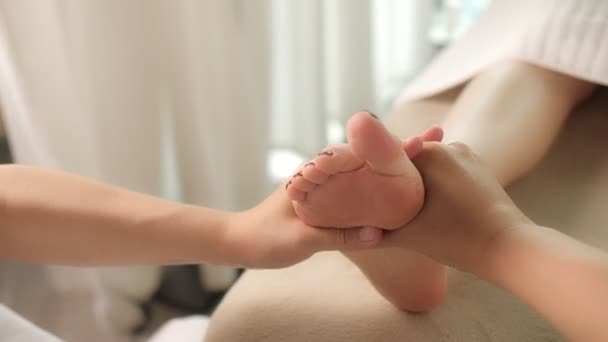 Primer plano manos maestras femeninas haciendo masaje reflexología del pie en salón de spa de belleza — Vídeo de stock