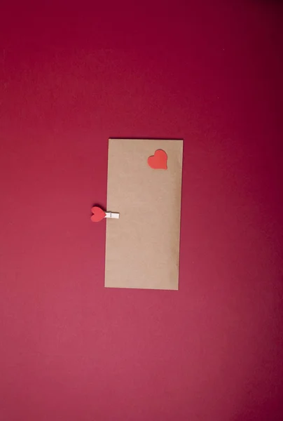 Craft envelope on red background. Congratulations. Love concept. Heart. Valentine, woman day gift card. 8 march