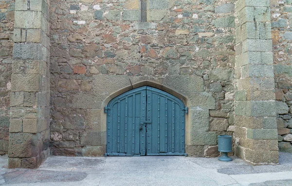 Solid castle wooden door arch door and stone wall close up