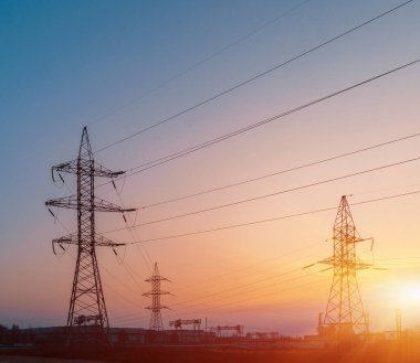 Yüksek voltajlı elektrik hatları. Elektrik dağıtım istasyonu. Yüksek voltajlı elektrik iletim kulesi. Güç hatları ve trafoları olan dağıtım elektrik santrali.