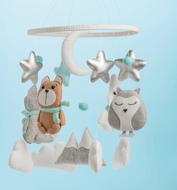 Çocuklar için yapılmış renkli ve çevre dostu bir cep telefonu. Ayı, tilki, baykuş, tavşan, dağ, yıldızlar, bulutlar ve balonlardan oluşur. Mavi arkaplanda el yapımı.