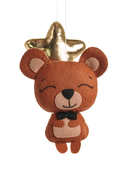 A felt toy in the form of a lovely bear, part of a children\'s mobile. On a white background. Colorful and eco-friendly children\'s mobile from felt for children.