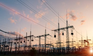 Akşamki elektrik iletim kulesinin silueti. Bir enerji santralinden bir şehre güç aktarımı